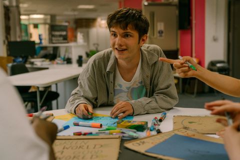 Photo of a student making a placard during a student society event