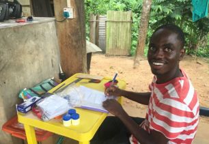 Albert Aryee labels plastic bags for collecting samples of leaves