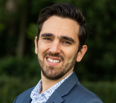 Portrait photograph of Brian O'Callaghan, a white man with dark hair and a beard.