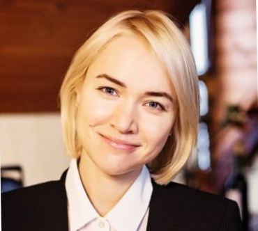 Portrait photograph of Dr Ievgeniia Kopytsia, a young white lady with short blonde hair.