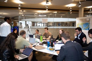 Students assigned to the DPRK (North Korea) room developing strategy