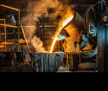 Pouring of liquid molten metal to casting mold using a forklift.