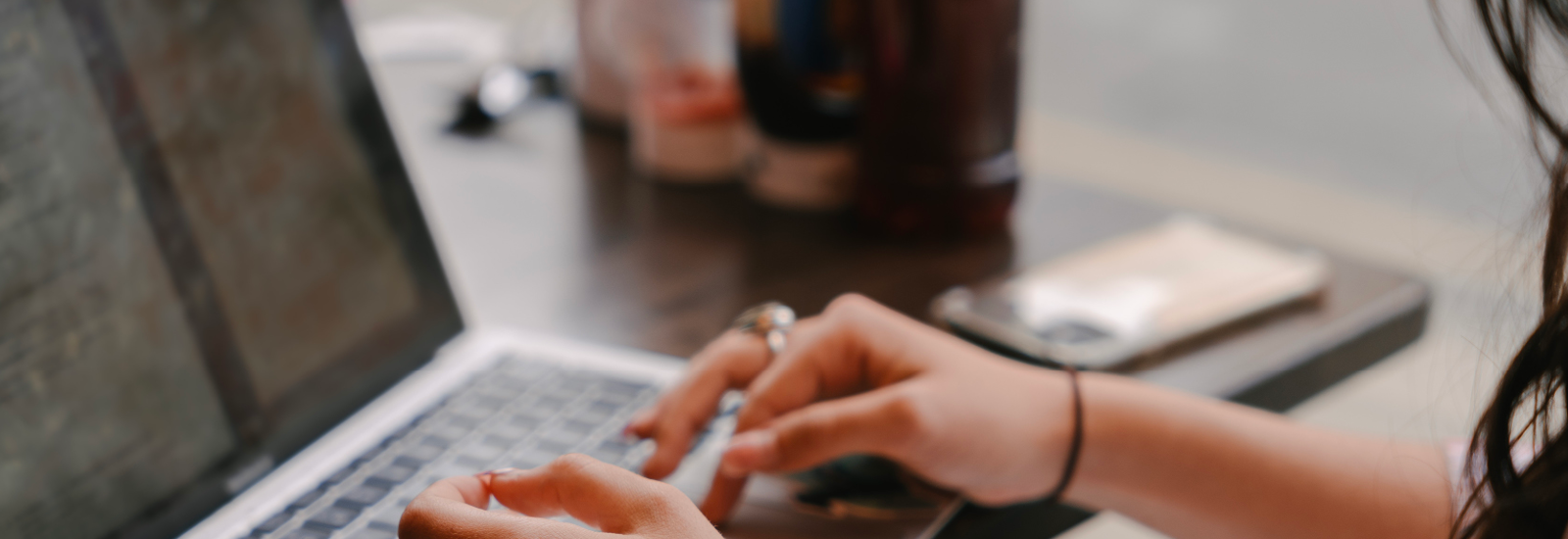 A student's hands typing on a laptop