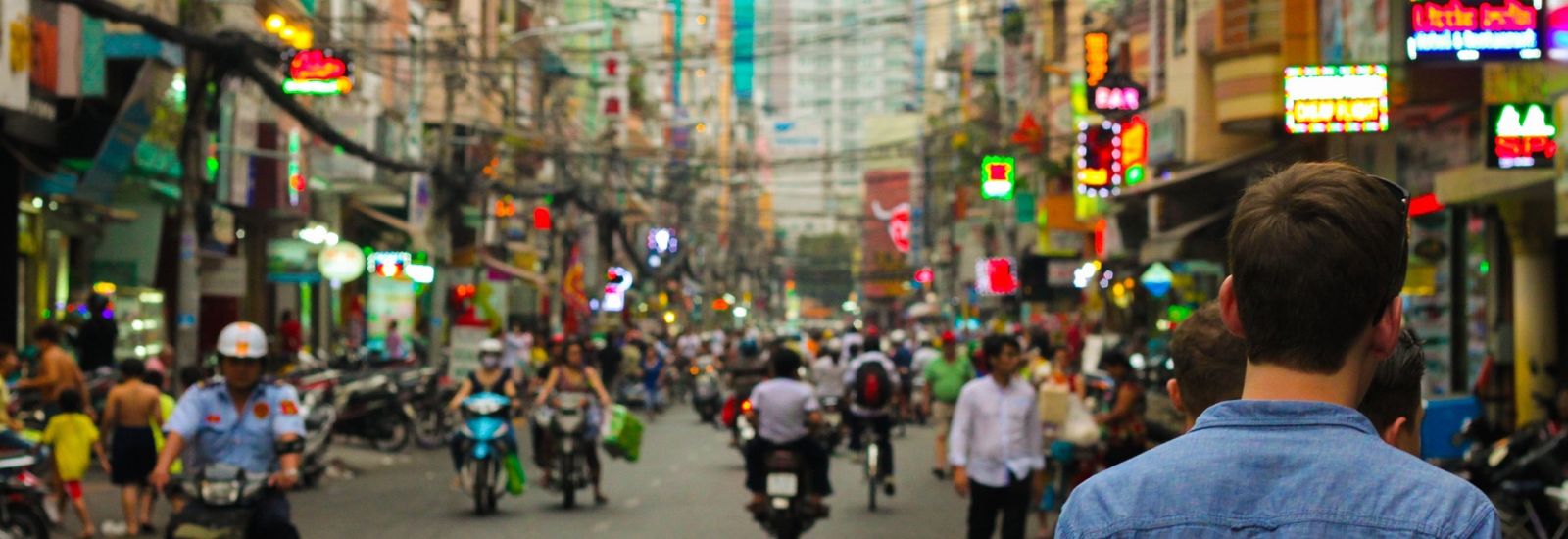 A male tourist standing in a busy street in China