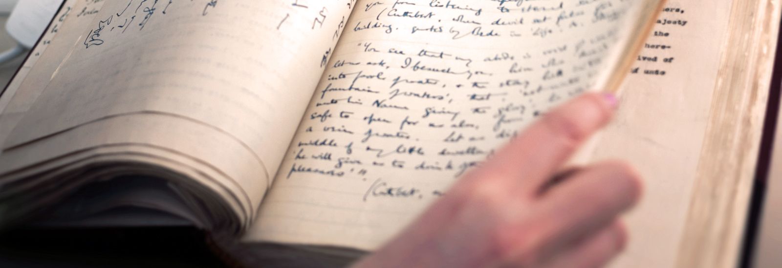 A close up of a book with handwritten text inside