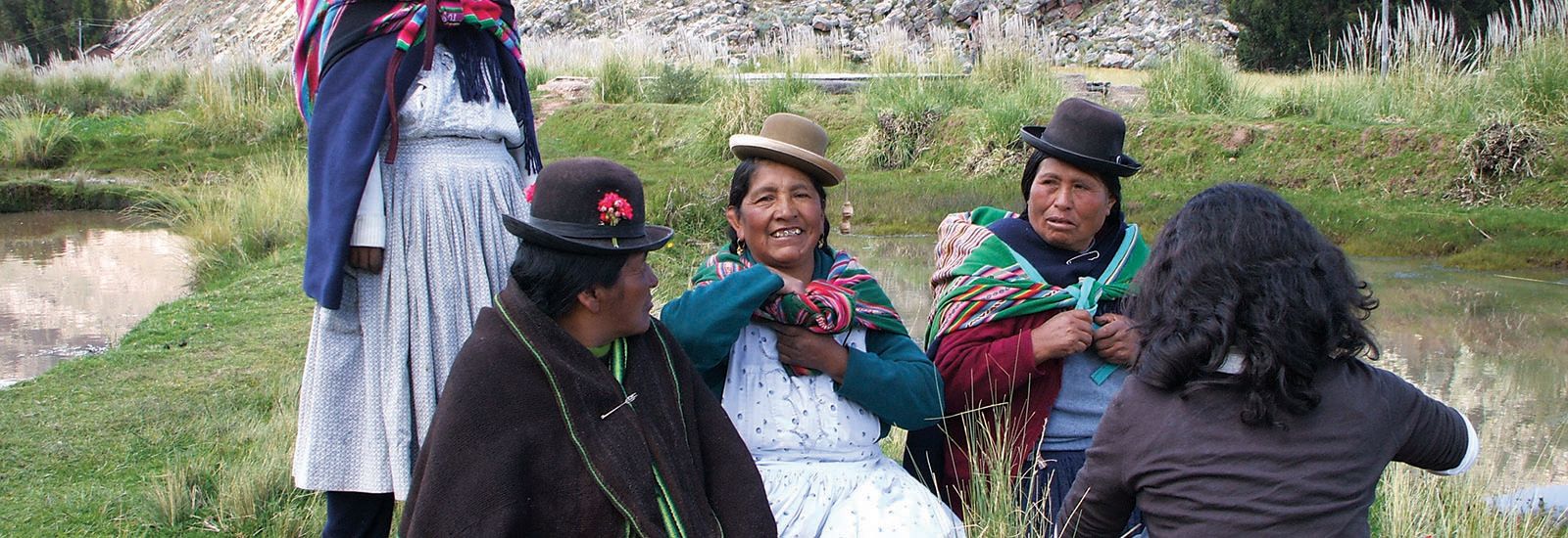 5 people with four in traditional Peruvian clothing