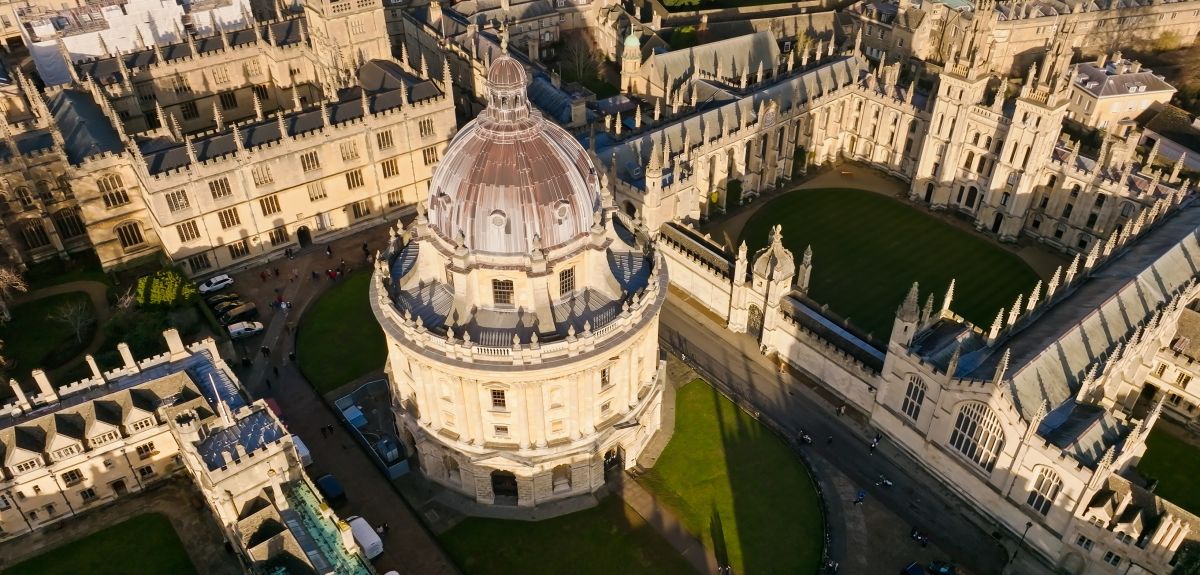 High angle drone shot of the Radcliffe Camera and All Souls College, historic University of Oxford buildings in the centre of Oxford.