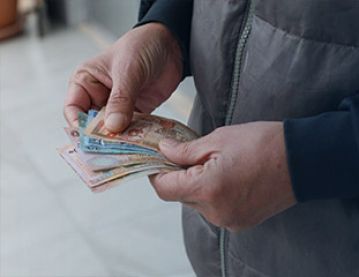 old man holding money