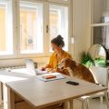 Woman using laptop with dog